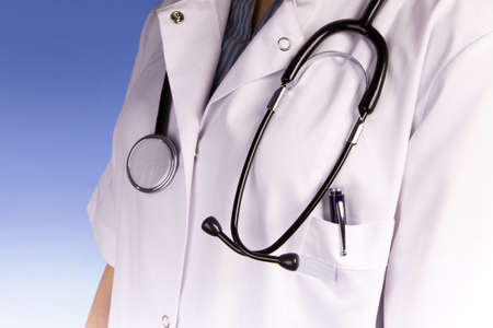 Nurse or doctor holding stethoscope in white scrubsの写真素材