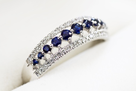 A white gold engagement ring with diamond and sapphire in a box.の写真素材