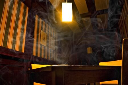 Smoke on black and yellow room backgroundの写真素材