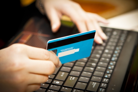 Hands entering credit card information into a laptopの写真素材