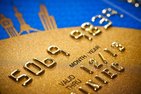 Close-up of silver digits on a credit card.