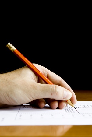Close-up of hand with a pencil on some document. Much space for copy.の写真素材