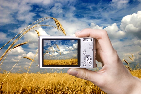 The digital camera in a hand  Landscapeの写真素材
