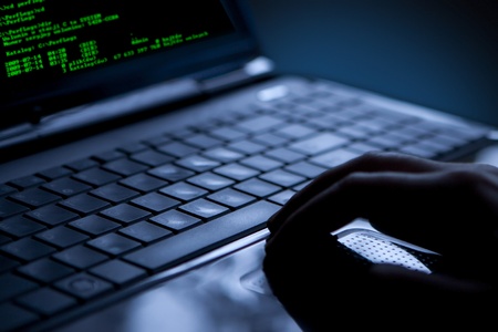 Hacker using laptop  Lots of digits on the computer screen の写真素材