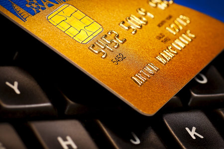 Macro of four credit card on a computer keyboard  Electronic online payment