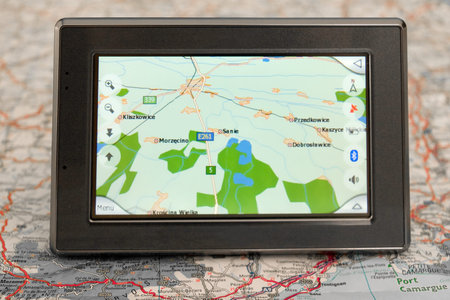 Portable GPS for a car sitting on a mapの写真素材