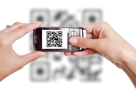 Human hands holding smart phone and scanning QR codeの写真素材