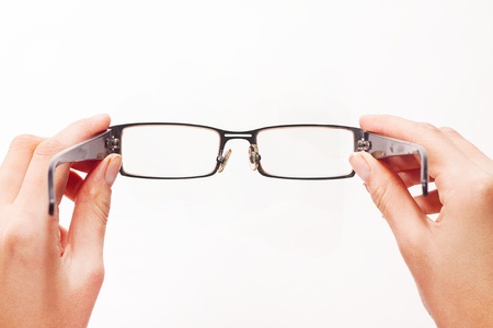 Hands holding eyeglasses on white background Hands holding eyeglasses on white background