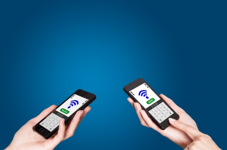 Two mobile phones with NFC payment technology  Near field communicationの写真素材
