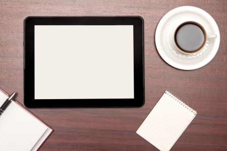 empty tablet and a cup of coffee on the deskの写真素材