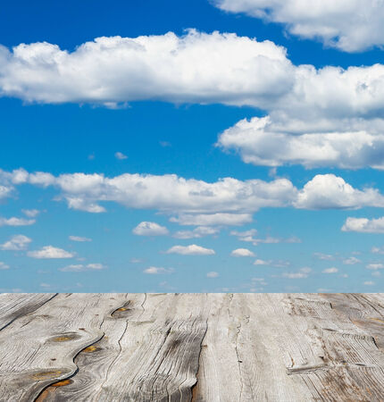 blue sky with clouds and wood planks floor の写真素材