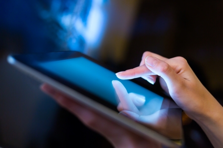 hand presses on screen digital tabletの写真素材