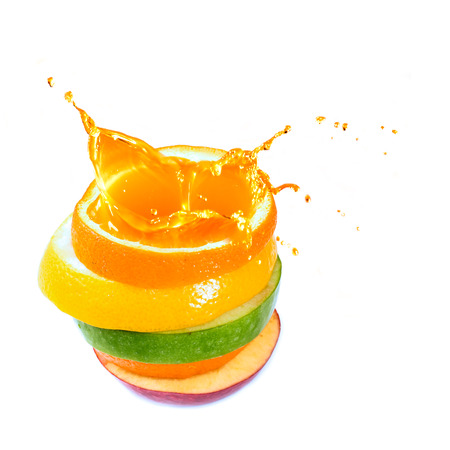 various type of fruit slices stacked with splashの写真素材