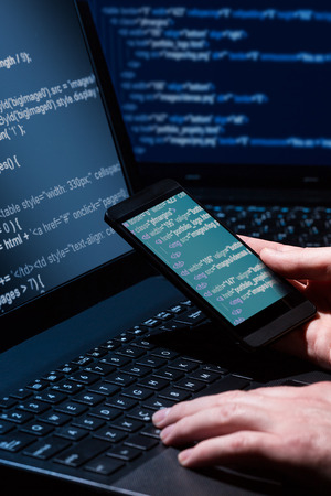 Hacker using laptop  Lots of digits on the computer screen の写真素材