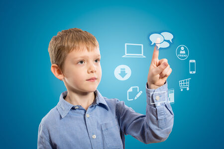 Boy accessing futuristic entertainment applications from the cloud computing interfaceの写真素材