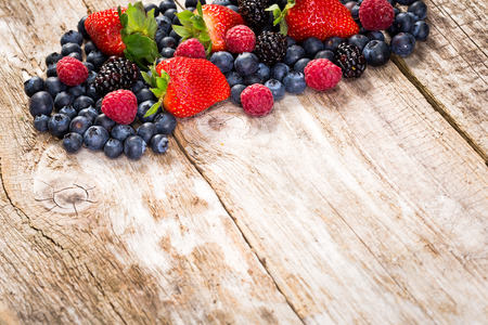 Fruit on wooden background  Summer or spring organic fruits over wood の写真素材