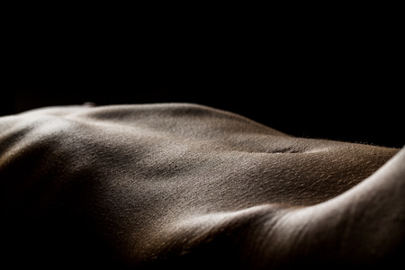 Nude woman bodyscape in black background の写真素材