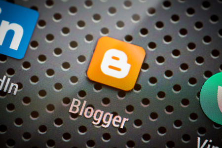 BELCHATOW, POLAND - APRIL 10, 2014: Closeup photo of Blogger icon on mobile phone screen. Popular social network.のeditorial素材