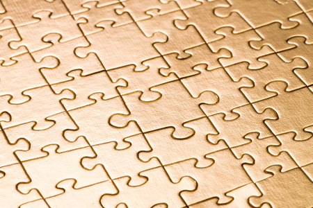 Gold jigsaw puzzle backgroundの写真素材