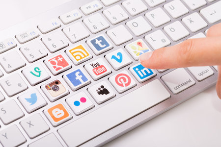 BELCHATOW, POLAND - AUGUST 31, 2014: Male hand pointing on key with a social media logotype...