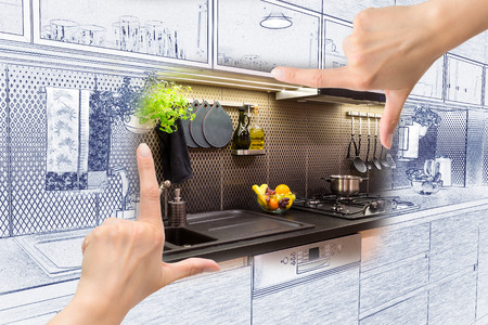 Female hands framing custom kitchen design. Combination drawing and photo.の写真素材