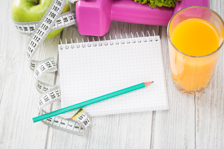 Workout and fitness dieting copy space diary on wooden table.の写真素材