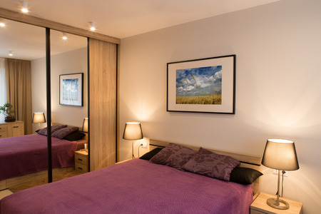 Luxury modern style bedroom. Purple bed and bedside lamp.の写真素材