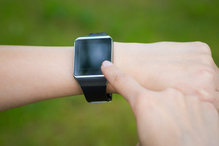 Woman holding and touch smart watch. Smartwatch concept.
