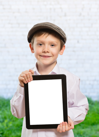 Happy boy with tablet computer. Child showing tabletの写真素材