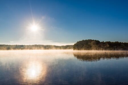 lake fog forest water sky sunlight sunrise mist landscape sun blue light design backgrounds - stock imageの写真素材
