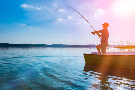fishing rod lake fisherman men sport summer lure sunset water outdoor sunrise fish - stock image の写真素材