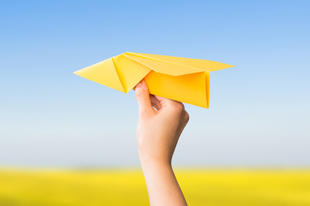 paper travel sky plane child flying yellow fun human leisure kid throw view throwing handmade freedom object up air airline joy concept - stock imageの写真素材
