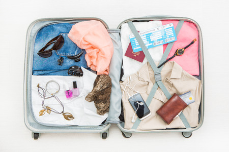 travel traveler traveling bag top open view packing card camera packed credit wallet clothing table leaving departure concept - stock imageの写真素材