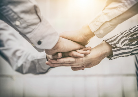 Group of business people enjoying and celebrating the success of team work. They consist hands upward in a gesture of victory.の写真素材