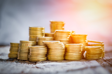 golden coin money stack save savings profit wooden table - stock imageの写真素材