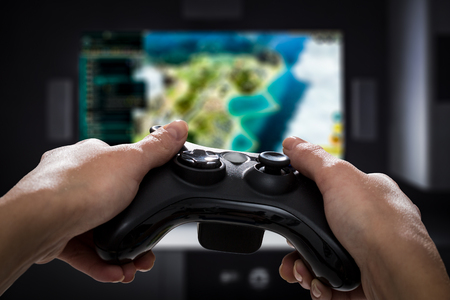 gaming game play tv fun gamer gamepad guy controller video console desktop playing player holding hobby playful enjoyment view concept - stock imageの写真素材