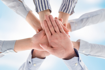 Business people hands stacked in a pile. A symbol of teamwork and trust.の写真素材