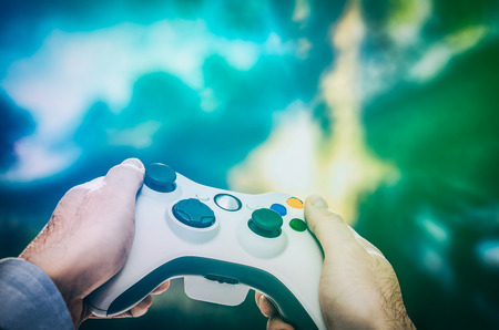 gaming game play tv fun gamer gamepad guy controller video console playing player holding hobby playful enjoyment view concept - stock imageの写真素材