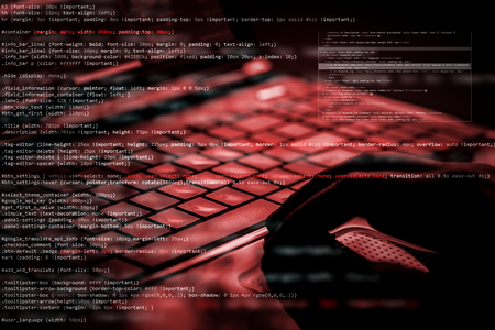 Hacker using laptop. Lots of digits on the computer screen.の写真素材