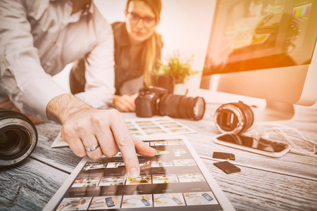 photographer journalist camera snapshot traveling teamwork team man male workroom woman female photo dslr editing edit hobbies lighting business designer concept - stock image