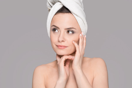 Perfect portrait of a young beautiful woman. Excellent skin and complexion. Copy space on a gray background. Topics of beauty and spa.の写真素材