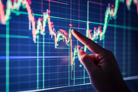 Businessman checking stock market data. Analysis economy data on forex earn graph.の写真素材
