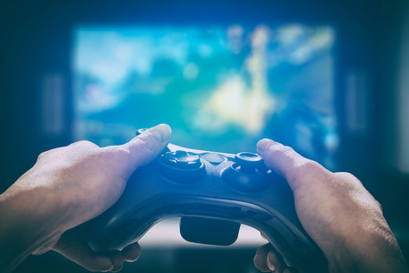 gaming game play tv fun gamer gamepad guy controller video console playing player holding hobby playful enjoyment view concept - stock imageの写真素材