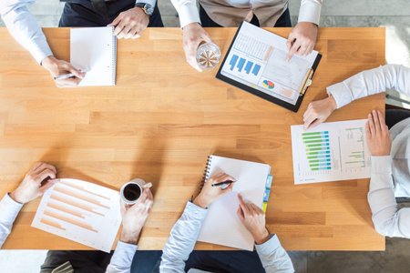 Business team analyzing financial documents or working on startup project. Teamwork and meeting...
