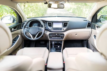 Luxury car interior - steering wheel, shift lever and dashboard.の写真素材