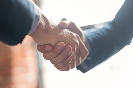 Business people shaking hands, finishing up meeting. Successful businessmen handshaking after good deal.の写真素材