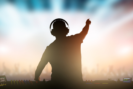 Charismatic disc jockey. Club, disco DJ playing and mixing music for crowd people.の写真素材