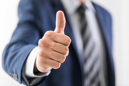 Business man shows thumb up sign gesture.の写真素材