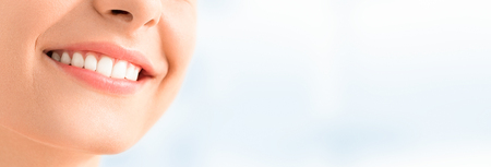 Beautiful smile young woman. White teeth on the master plan. Free space and background to use.の写真素材
