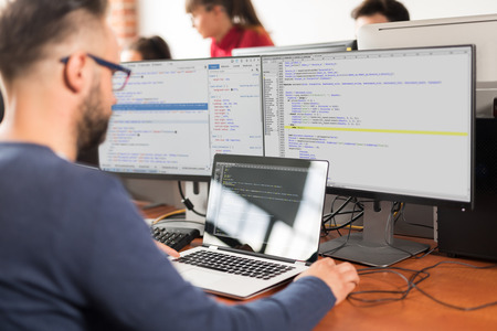 Developing programming and coding technologies. Website design. Programmer working in a software develop company office.の写真素材